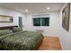 Serene main bedroom with a comfortable bed, stylish decor, and ample natural light at 8950 W 26Th, Lakewood, CO 80215