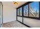 Cozy sunroom area with mosaic tile floors, and large windows, providing a relaxing view of the outdoors at 1050 N Corona St # 308, Denver, CO 80218