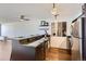 Bright kitchen with granite countertops, stainless steel appliances, and open shelving offers a modern and efficient cooking space at 1050 N Corona St # 308, Denver, CO 80218