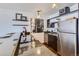 Modern kitchen featuring granite countertops, stainless steel appliances, and stylish open shelving, offering both beauty and functionality at 1050 N Corona St # 308, Denver, CO 80218