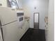 Compact kitchen with essential appliances and vintage cabinetry at 1050 N Corona St # 308, Denver, CO 80218