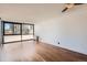 This is an empty living room featuring hardwood floors and a large window at 1050 N Corona St # 308, Denver, CO 80218