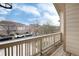 Balcony with wood floors and a view of townhouses and parked cars at 341 Granby Way # A, Aurora, CO 80011