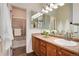 Clean bathroom featuring a vanity with wooden cabinets, a shower with glass doors, and a well-lit mirror, perfect for relaxation at 341 Granby Way # A, Aurora, CO 80011