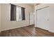 Cozy bedroom with a large window, closet, and hardwood floors providing ample space and natural light at 341 Granby Way # A, Aurora, CO 80011