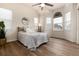 Bright bedroom features a ceiling fan, arched windows, and hardwood flooring at 341 Granby Way # A, Aurora, CO 80011