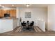 Bright dining area features a modern round table and stylish decor, complemented by wood-look floors at 341 Granby Way # A, Aurora, CO 80011