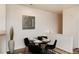 Close up on the dining area, featuring a round table and modern place settings, illuminated by recessed lighting at 341 Granby Way # A, Aurora, CO 80011