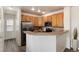 Well-lit kitchen featuring wooden cabinets, stainless steel appliances, and a breakfast bar, ideal for casual dining at 341 Granby Way # A, Aurora, CO 80011