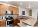 Functional kitchen with stainless steel appliances, ample counter space, and a stylish backsplash, perfect for cooking at 341 Granby Way # A, Aurora, CO 80011