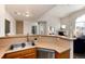 Open-concept kitchen with a breakfast bar overlooking a living area, featuring stainless steel appliances and ample countertop space at 341 Granby Way # A, Aurora, CO 80011