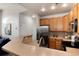 Well-equipped kitchen with stainless steel appliances, a breakfast bar, and wooden cabinetry, offering functionality and style at 341 Granby Way # A, Aurora, CO 80011