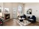 Bright living room with a fireplace, large windows, and stylish decor at 341 Granby Way # A, Aurora, CO 80011