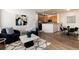 Cozy living room featuring modern decor and stylish furniture, seamlessly flowing into the kitchen and dining area at 341 Granby Way # A, Aurora, CO 80011
