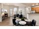 Open-concept living and dining area with a fireplace, hardwood floors, and contemporary furnishings at 341 Granby Way # A, Aurora, CO 80011