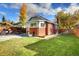 Lush backyard features a well-manicured lawn, garden beds, and a patio at 3315 N Stuart St, Denver, CO 80212