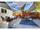 Outdoor patio with stylish furniture, string lights, and shade sails for relaxation at 3315 N Stuart St, Denver, CO 80212
