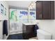 Charming bathroom featuring dark vanity, stylish lighting, and fun shower curtain at 3315 N Stuart St, Denver, CO 80212