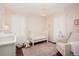Charming Bedroom with soft pink tones, white furniture, and plenty of natural light at 3315 N Stuart St, Denver, CO 80212