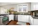 Well-lit kitchen with sleek countertops, stainless steel dishwasher, and ample cabinet space at 3315 N Stuart St, Denver, CO 80212