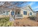 Charming backyard with a stone facade, small deck, and well-maintained landscaping at 7633 S Addison Way, Aurora, CO 80016
