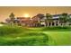 Stunning view of the Heritage Eagle Bend Golf Club with sunset in the background and rolling green hills at 7633 S Addison Way, Aurora, CO 80016