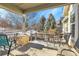 Enjoy this comfortable covered patio with views of the backyard and plenty of space for seating at 7633 S Addison Way, Aurora, CO 80016