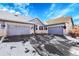 Exterior shot of home featuring a three car garage and beautiful blue sky at 7633 S Addison Way, Aurora, CO 80016
