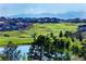Beautiful golf course view with lush green fairways, serene pond and homes in the Heritage Eagle Bend community at 7633 S Addison Way, Aurora, CO 80016