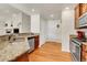 Kitchen featuring granite countertops, stainless appliances, and hardwood flooring at 7633 S Addison Way, Aurora, CO 80016
