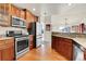 Bright kitchen with stainless steel appliances and hardwood floors at 7633 S Addison Way, Aurora, CO 80016
