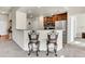 Kitchen view with granite counters, stainless appliances, and modern bar stools at 7633 S Addison Way, Aurora, CO 80016