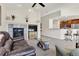 Spacious living room featuring a fireplace and an open view to the kitchen at 7633 S Addison Way, Aurora, CO 80016
