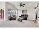 Bright living room with vaulted ceilings, large windows, and cozy fireplace at 7633 S Addison Way, Aurora, CO 80016