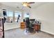 Functional home office with a large window, ceiling fan, and ample workspace for productivity at 7633 S Addison Way, Aurora, CO 80016