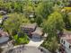 Aerial view of a neighborhood featuring mature trees, houses with lawns, and a cul-de-sac at 4175 S Sidney Ct, Denver, CO 80237
