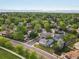 Panoramic aerial view of a neighborhood with tree-lined streets and mountain views in the distance at 4175 S Sidney Ct, Denver, CO 80237