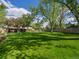 Large backyard with well-maintained lawn and mature trees providing ample shade at 4175 S Sidney Ct, Denver, CO 80237