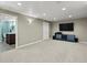 Finished basement with neutral walls and carpeting, adjacent bathroom and entertainment area at 4175 S Sidney Ct, Denver, CO 80237