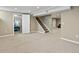 Finished basement area featuring neutral carpeting, white trim, and an adjacent bedroom at 4175 S Sidney Ct, Denver, CO 80237