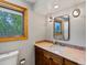 Bathroom features a wood framed window, tan marble counter tops and a white sink at 4175 S Sidney Ct, Denver, CO 80237