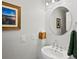 Chic powder room featuring a sleek pedestal sink and tasteful decor at 4175 S Sidney Ct, Denver, CO 80237