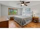 Cozy bedroom with hardwood floors and a view of the lush outdoors at 4175 S Sidney Ct, Denver, CO 80237