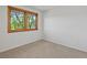 Bright bedroom with window that has a view of the lush outdoors at 4175 S Sidney Ct, Denver, CO 80237