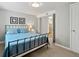 Comfortable bedroom with blue bedding, neutral walls, adjacent bathroom at 4175 S Sidney Ct, Denver, CO 80237