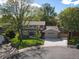 An elevated shot of a two-story home featuring a well-kept lawn, driveway, and mature trees at 4175 S Sidney Ct, Denver, CO 80237