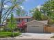This is a two-story home with a well-kept lawn, mature trees, driveway, and stone accents at 4175 S Sidney Ct, Denver, CO 80237