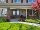 Well-maintained front yard leading to a covered front door, stone accents, and manicured landscaping at 4175 S Sidney Ct, Denver, CO 80237
