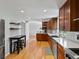 Well-equipped kitchen featuring stainless steel appliances, custom cabinets, and modern finishes at 4175 S Sidney Ct, Denver, CO 80237