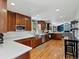 Spacious kitchen with stainless steel appliances, white countertops, and custom wood cabinetry at 4175 S Sidney Ct, Denver, CO 80237